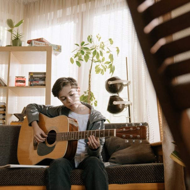A boy playing the guitar